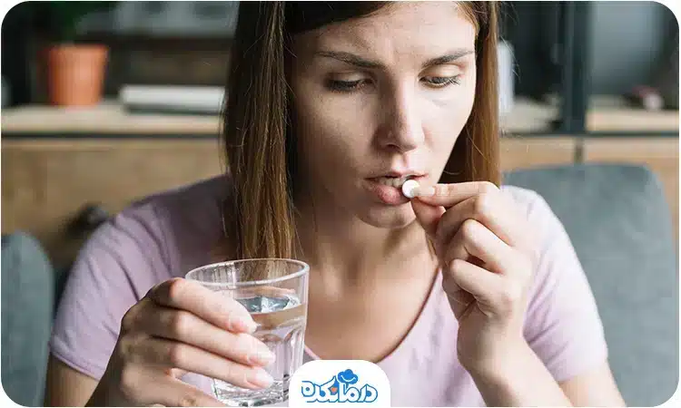  یک زن جوان در حال خوردن قرص