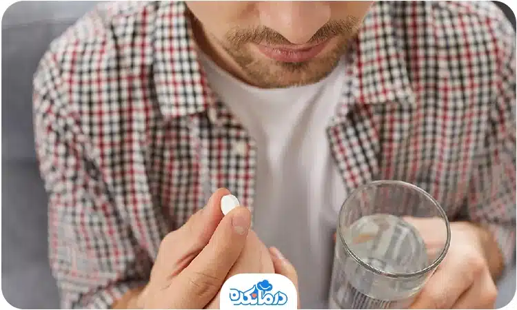 یک مرد جوان در حال خوردن قرص